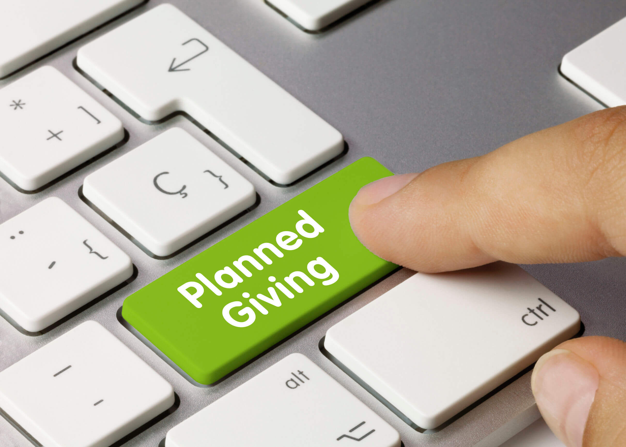 Image of a computer keyboard with a “planned giving” button, representing how estate planning and charitable giving attorney Anna M. Price helps clients with planning charitable giving in the context of overall estate planning.