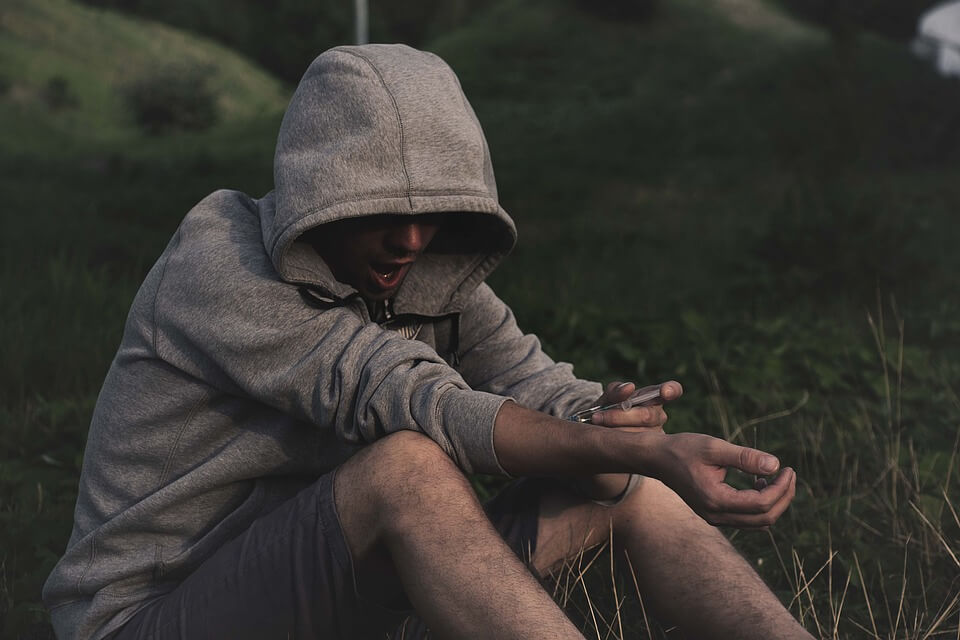 Image of an addicted person shooting up, representing the difficulty of estate planning for addicted family members and how attorney Anna M. Price of Jenkins Fenstermaker can help WV, KY, and OH estate planning clients.