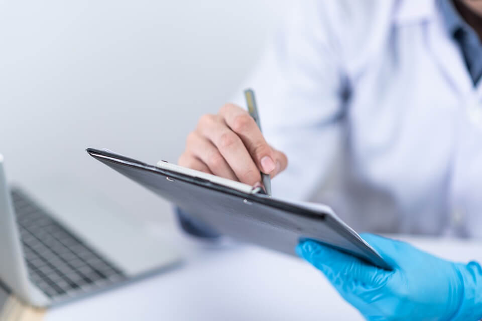 Image of a doctor with a clipboard and pen, representing how a WV living can help ensure your wishes are respected in the event you become incapacitated.