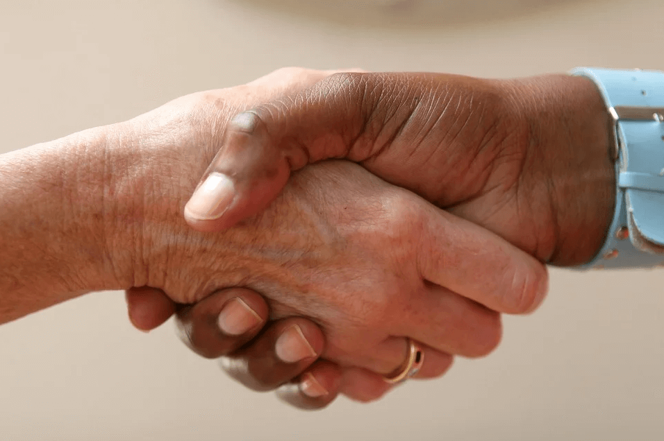 Image of a handshake, representing how entrepreneur and M&A lawyers at Jenkins Fenstermaker, PLLC can help negotiate and protect your interests in restaurant M&A transactions.