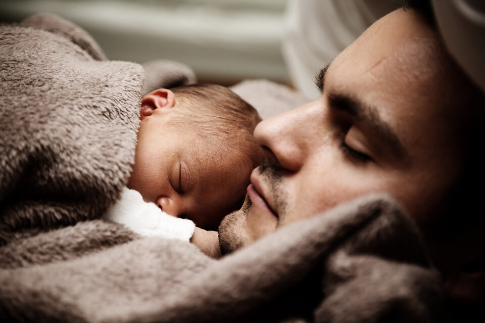 Photo of an infant and father, who can rest easy because he completed his deportation estate planning with the help of Anna M. Price at Jenkins Fenstermaker, PLLC.