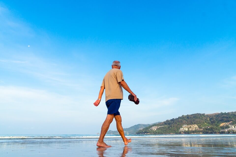 Image of a senior man walking on the beach, representing the need to include Medicare and Medicaid in your estate plan and how an experienced West Virginia (WV) estate planning attorney like Anna M. Price can help.