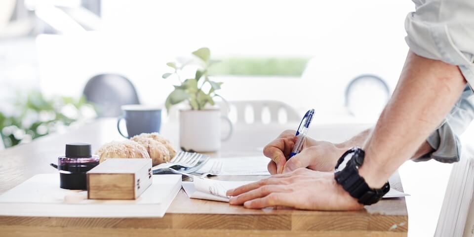 Image of a man completing an estate planning intake form, taking the necessary steps to ensure his health care and final property wishes are honored while protecting his loved ones after he is gone.