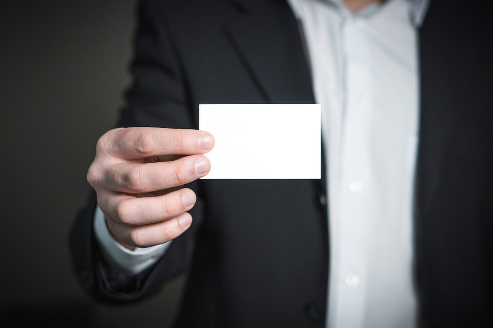 Image of a professional in a business suit handing out a business card, representing how the Best Lawyers in America© 2019 Charleston, WV “Best Lawyer of the Year” recipients represent the caliber of legal services at Jenkins Fenstermaker, PLLC.