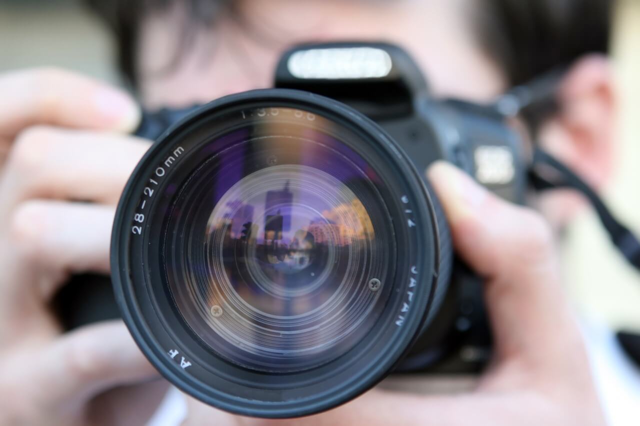 Image of a man with a camera, representing how some WV employers perform workers compensation claimant surveillance unaware of the laws governing such actions.