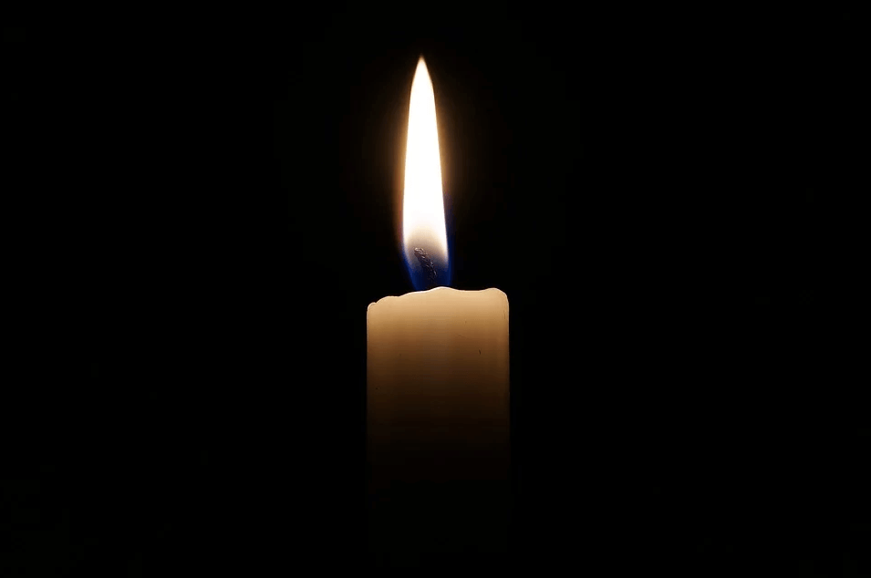 Image of a single candle flame in a dark room, representing the serious discussions with Anna M. Price, an experienced estate planning attorney at Jenkins Fenstermaker, to learn how to use no-contest clauses to avoid conflict.