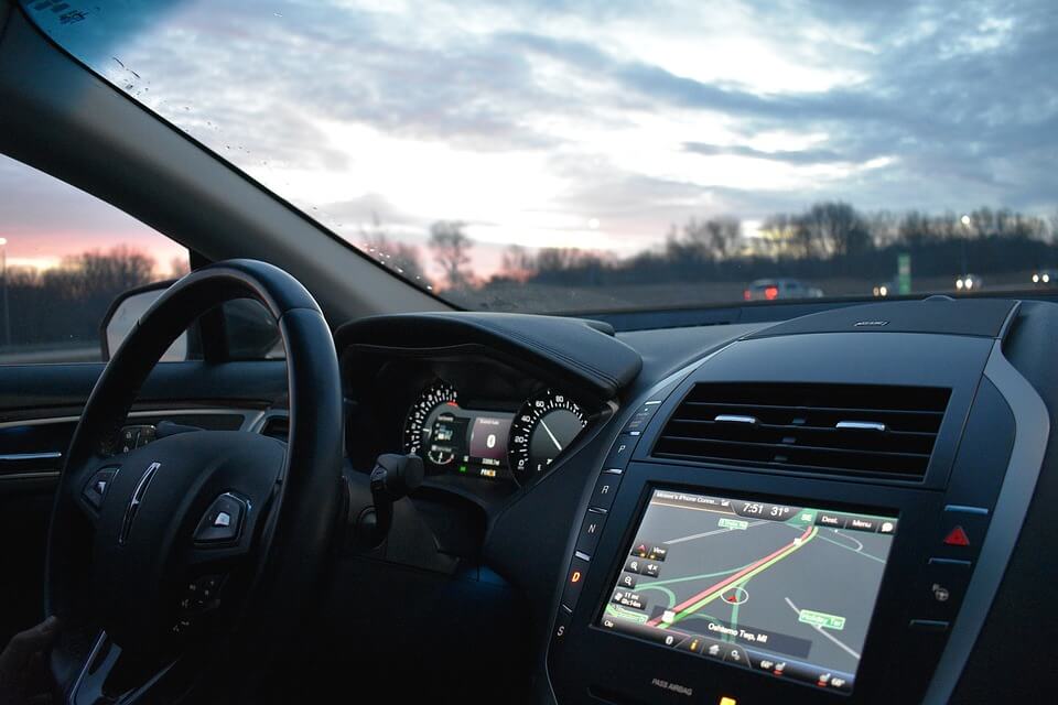 Image of the dashboard of a car, including the navigation system, representing the potential effects of transportation network companies in WV.