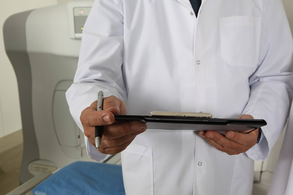 Image of a doctor reviewing a patient's file, representing the WV Supreme Court of Appeal's decision allowing PPD award reduction in a workers' compensation appeal.