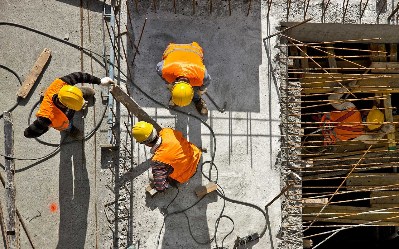 Workers on a jobsite represent the need for employers and insurers to understand workers’ compensation compensability in WV.