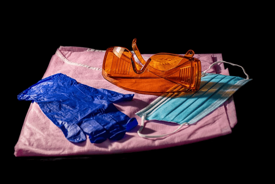  Image of a face mask, rubber gloves, and protective eyewear, representing how Jenkins Fenstermaker’s workers’ compensation defense attorneys help employers understand and deal with COVID-19’s effect on workers’ compensation law and proceedings.