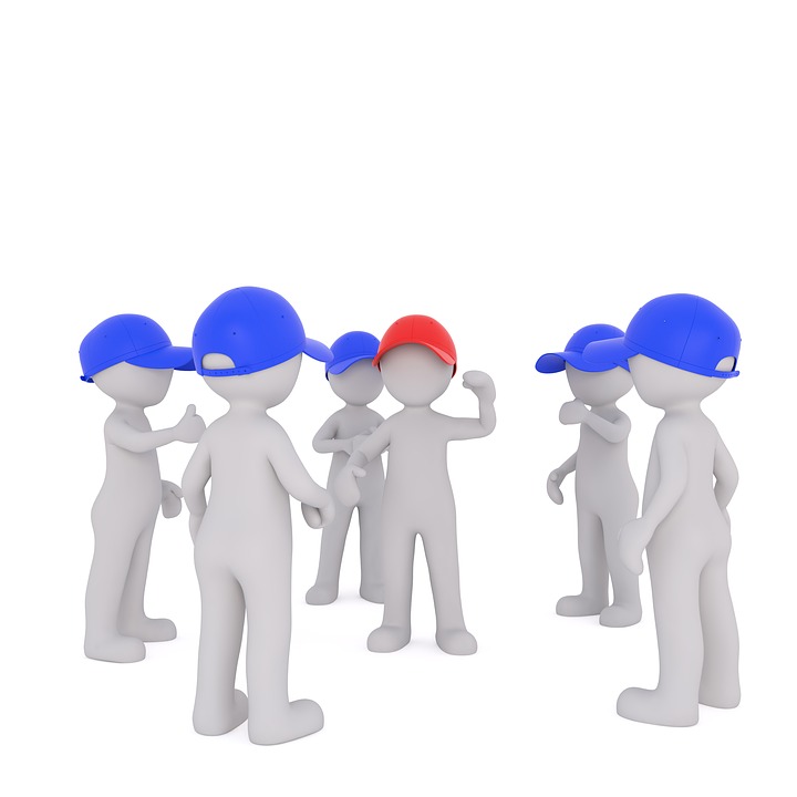 Image of a group of figures in blue hats surrounding one figure wearing a red hat, representing the NLRB's shift from allowing micro-unions to its more recent decision disallowing them in the PCC Structurals case.