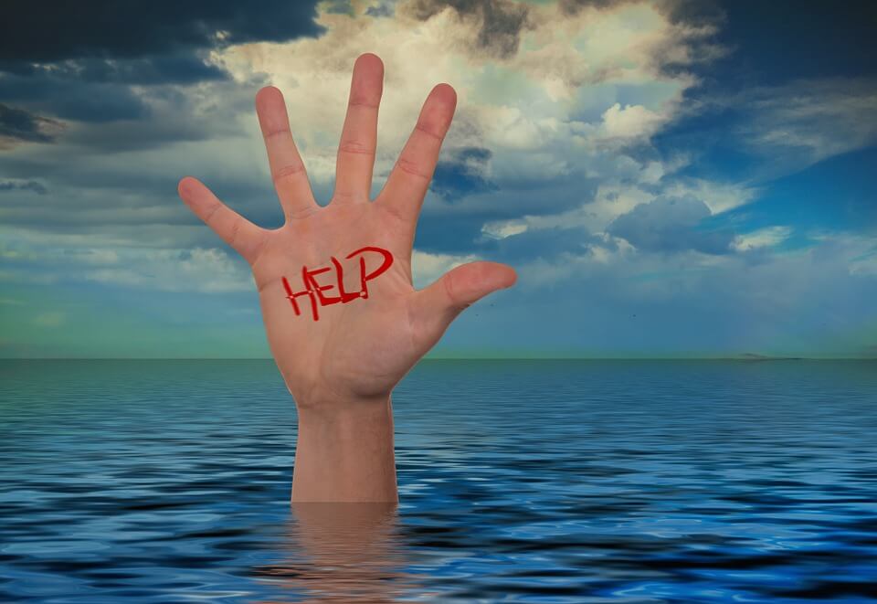 Image of a hand marked “help,” sticking up out of a body of water, representing how Anna M. Price at Jenkins Fenstermaker, PLLC can help with estate planning for emergencies.