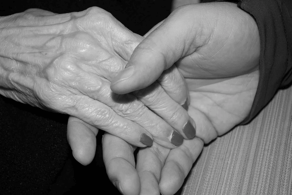 An image of two hands being held, one older and one younger, representing how West Virginia guardianship lawyer Anna M. Price can help guardians and protected persons in West Virginia adult guardianship proceedings.