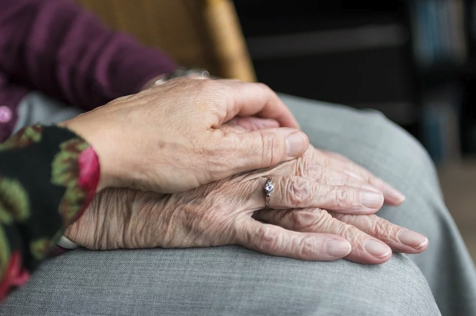 Image of a young person’s hand holding an older woman’s hand, representing how Ohio guardianship lawyer Anna Price helps guardians and wards through proceedings regarding adult guardianship in Ohio.