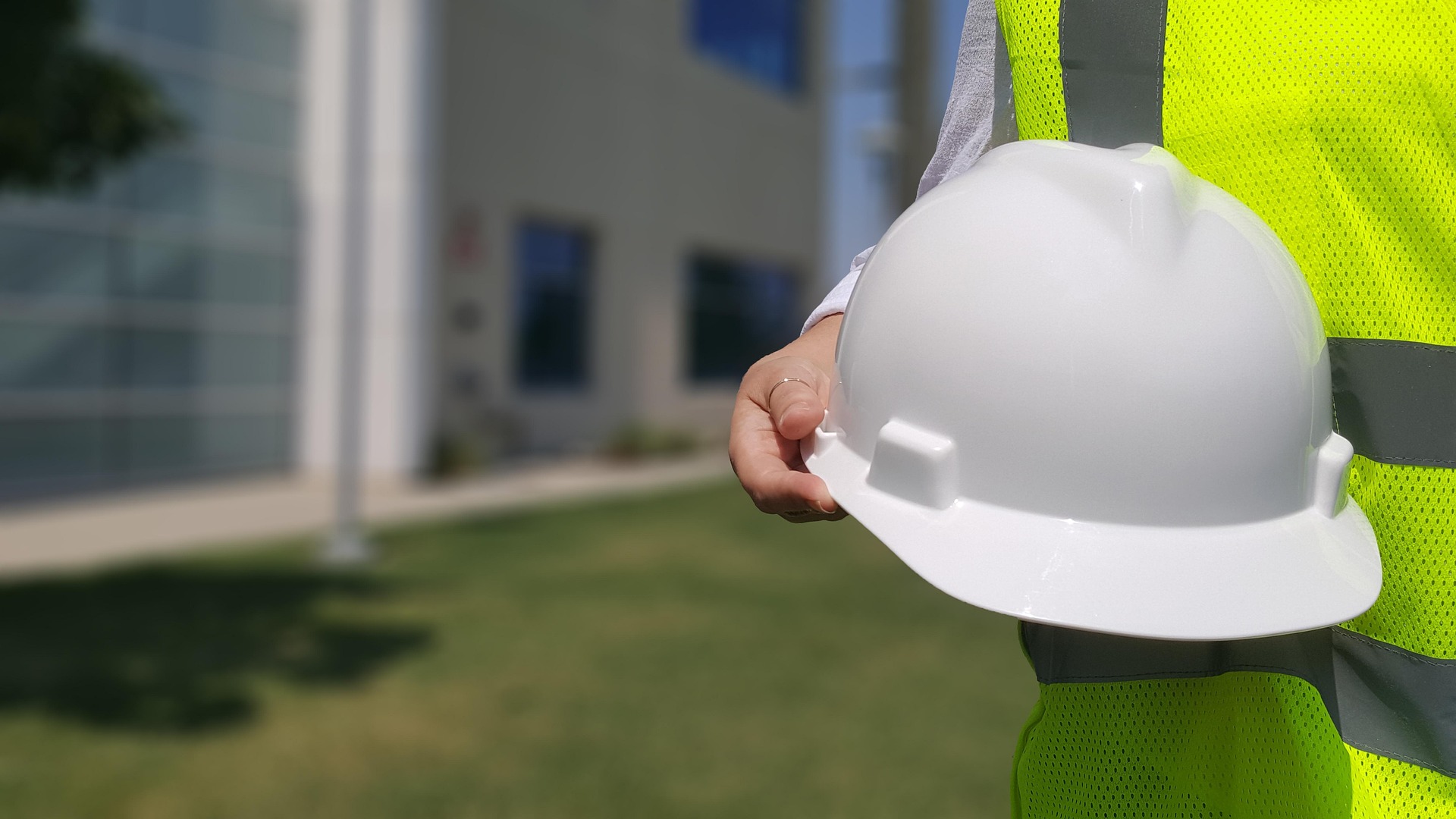 Person holding a hard hat, representing the need for employers to understand compensability of workers’ compensation claims in WV.