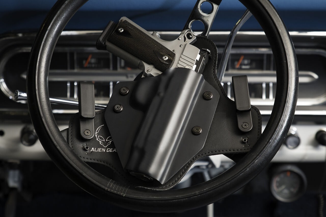 An image of a handgun attached to a vehicle’s steering wheel, representing recent developments in WV gun laws for businesses in vehicles in parking lots and how attorney Stephen J. Golder can help you understand how these laws affect your business.