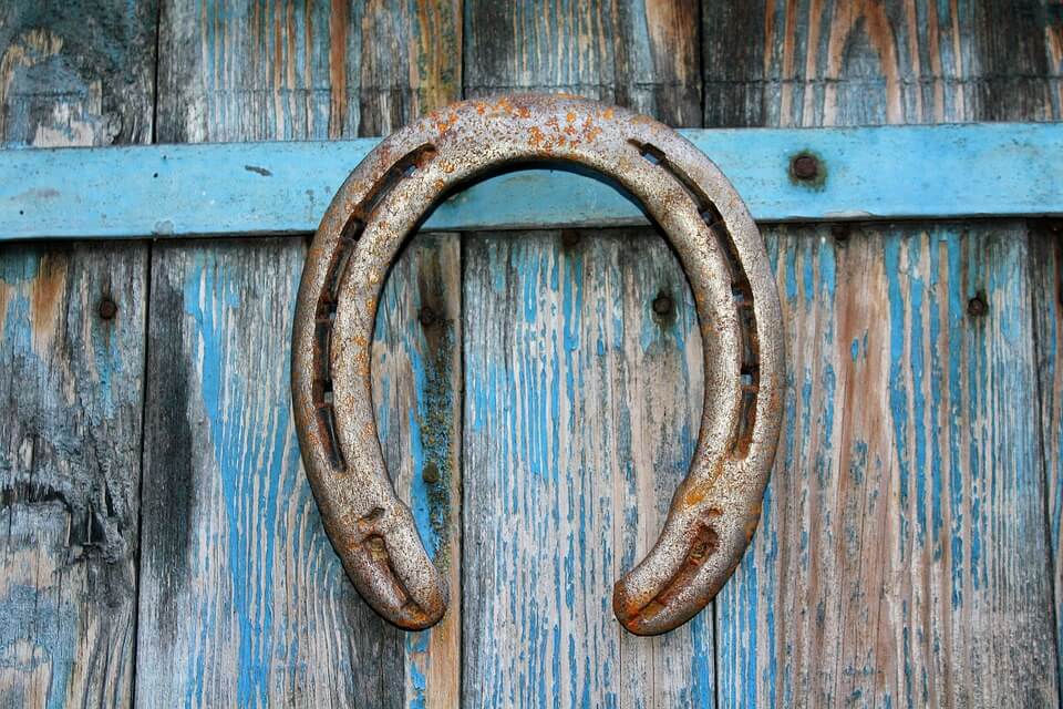 Image of a horseshoe on a barn door, representing the importance of attention to equine liability issues and the need for knowledgeable equine attorneys in WV and elsewhere.