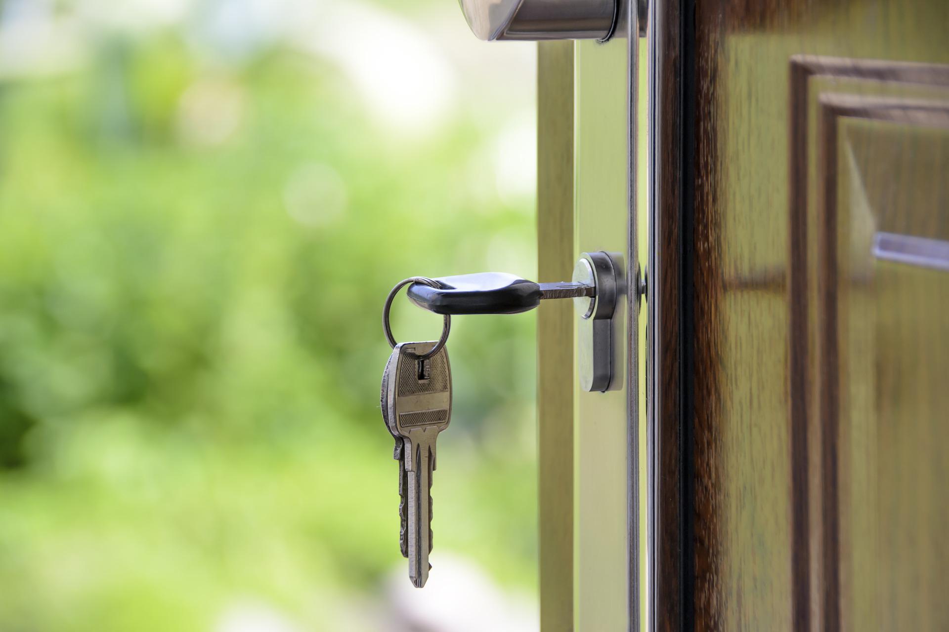 Image of a set of keys in a door, representing the common reasons for house closing delays and how WV residential closing attorney Allison Farrell at Jenkins Fenstermaker, PLLC in Clarksburg can help.