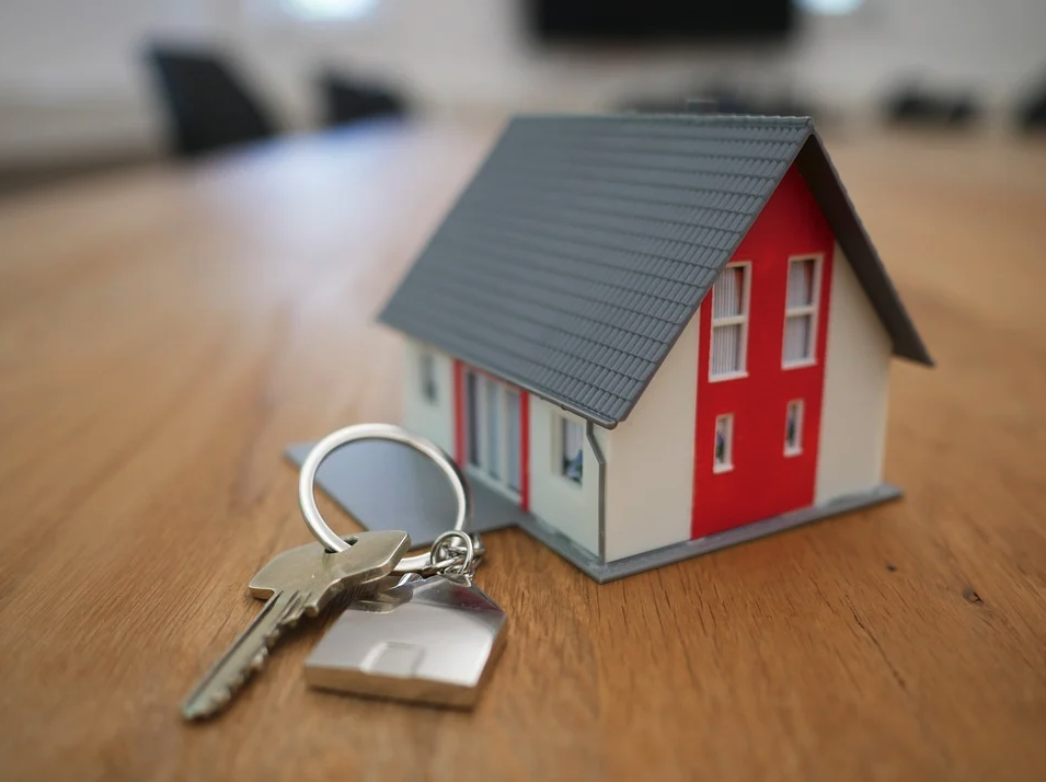 Image of a toy home and key, representing the need to consult with a West Virginia real estate lawyer from Jenkins Fenstermaker, PLLC for protection in residential transactions and disputes.