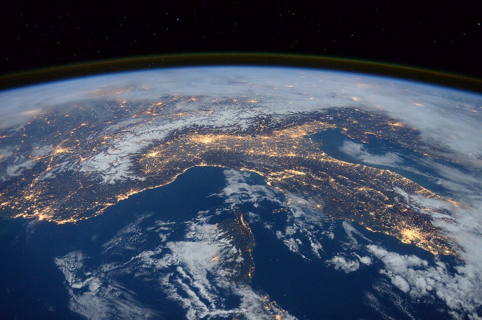 An image of the earth from space with lights connecting the continents, representing how globalization is making international estate planning issues prevalent for more families in the US and abroad.