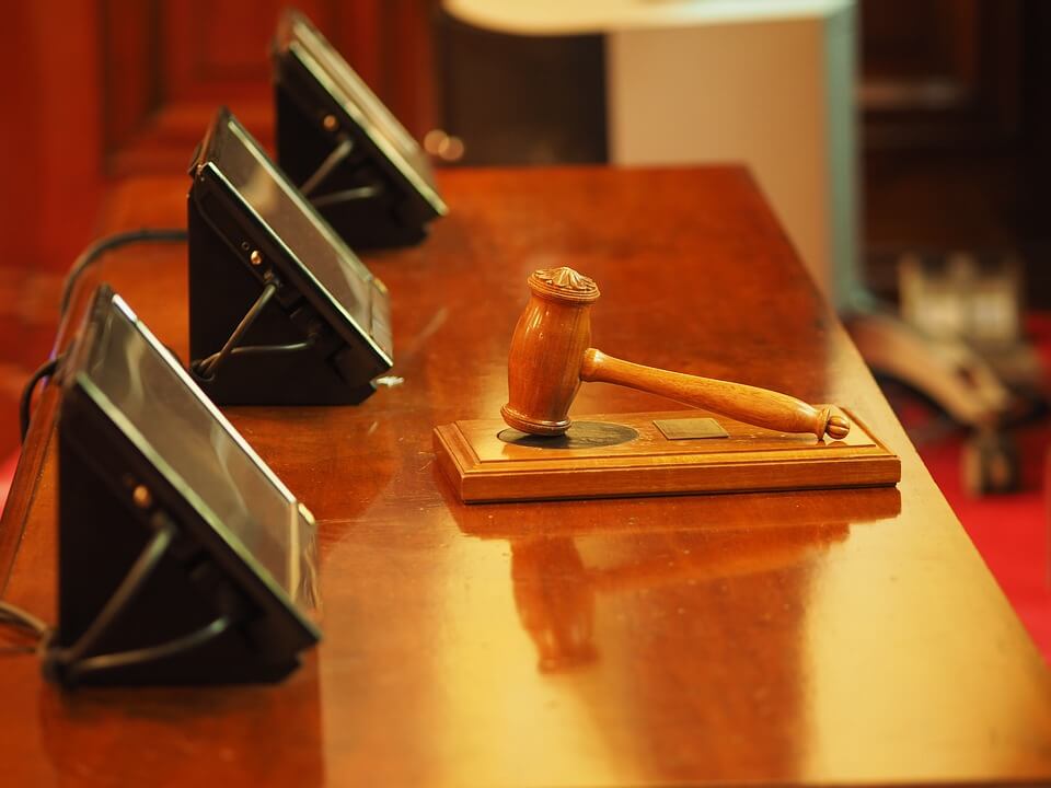 Image of a table set up for a three-judge panel, representing how Jenkins Fenstermaker helps employers understand what an appointment to the WV Workers’ Compensation Board of Review and supreme court decisions mean to WV workers’ compensation trends.