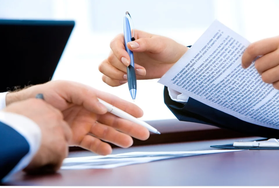 Image of two attorneys reviewing documents by a laptop, representing how the tristate appellate lawyers at Jenkins Fenstermaker, PLLC provide in-depth experience and dedication to all appellate clients.
