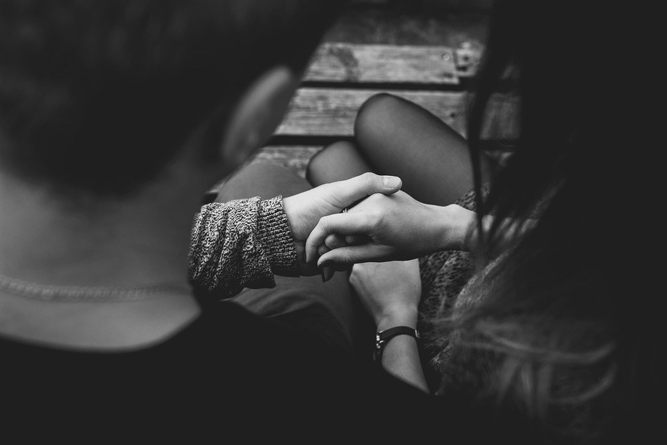 Image of a couple holding hands who have lost a loved one, representing how Jenkins Fenstermaker attorneys can help them prepare for probate of a will in WV.