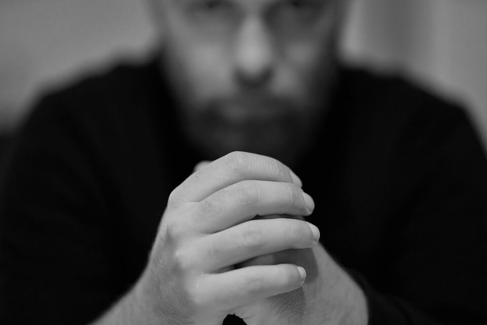 Image of a depressed manager, representing defense of psychiatric worker's compensation claims and how damaging those claims can be to a business.