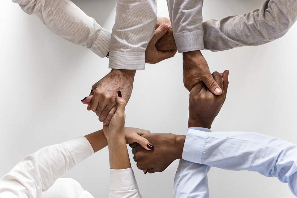 An image of interlinked hands, representing the effective, collaborative approach a business law attorney at Jenkins Fenstermaker will take to help you achieve your specific legal goals.