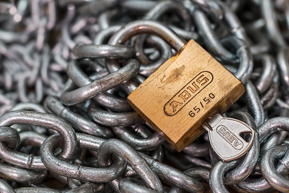 Image of lock, chains, and key, illustrating how surety bonds and other surety providers provide security for a judgment creditor while a case is on appeal and the effect of Rule 65.1 amendment on proceedings against security providers.