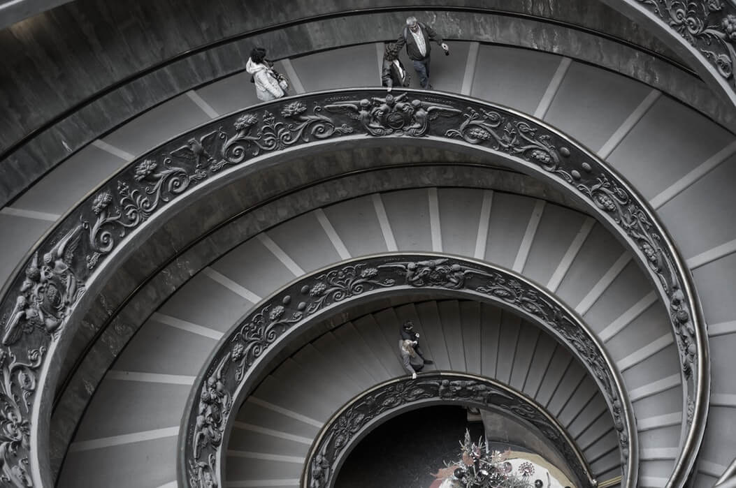 Image of a people walking on a spiral staircase, representing the different levels of the WV magistrate court jurisdiction.