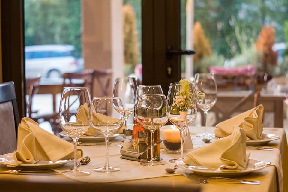 Image of a table at a restaurant with a plate of food and a cup of coffee on it, representing the need to seek advice from an experienced workers' compensation attorney regarding the law on WV workers' compensation meal reimbursement.