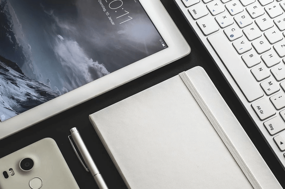 Image of a tablet, cell phone, notebook, and keyboard, representing the need to discuss a digital property estate plan with a knowledgeable attorney who can help you determine how to protect your digital assets if a tragedy occurs.