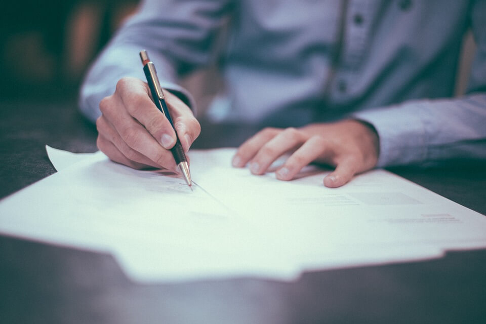 Image of a man signing an Ohio power of attorney, representing one of the many comprehensive estate planning services offered by Anna M. Price of Jenkins Fenstermaker.